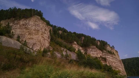 Panning summer day time-lapse of fast moving clouds over the mountain, valley Stock Footage 75868789