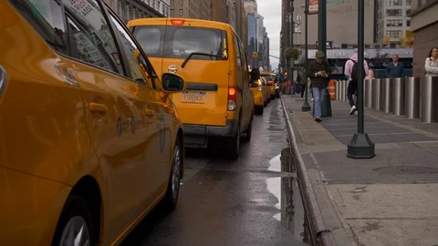 Panning Up On Taxi Cabs Lined Up And Driving Away On NYC Street Stock Footage 114040718