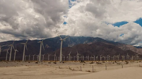 Panning time lapse of clouds passing over wind turbines in Palm Springs Stock Footage 33841401