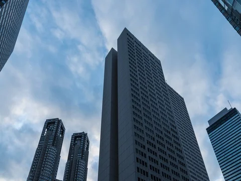 Panning time-lapse footage of the cloudy sky over Shinjuku business area Stock Footage 76387629