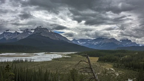 Panning Time-lapse of Mountains, River, and Dramatic Clouds in 4K Vídeo Stock 95378963
