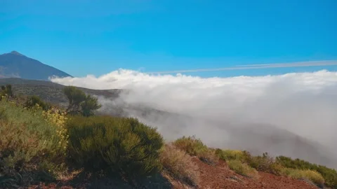 Panning timelapse above sea of clouds on volcanic slope, Mount Teide in backgrou Stock-Footage 335018331