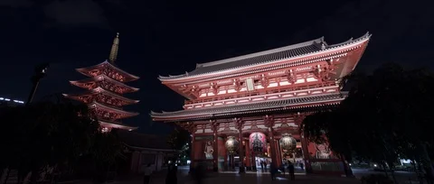 Panning Timelapse shot of light up temple, people walking around at night, Tokyo Stock Footage 136137196