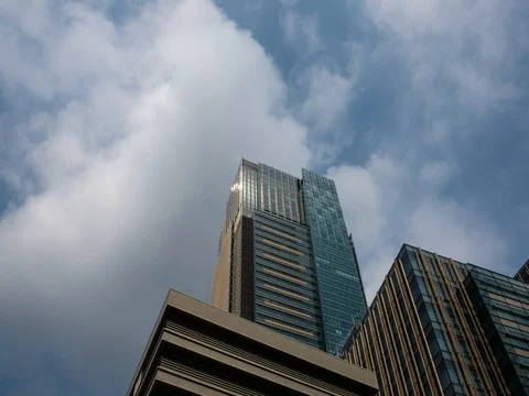 Panning timelapse of white clouds over office building in the Roppongi area Stock Footage 80618692