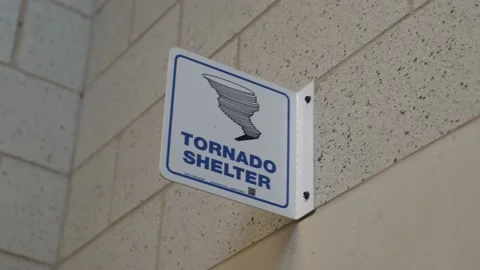 Panning tornado shelter sign Stock Footage