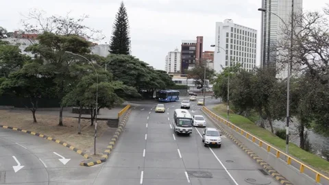 Panning up of traffic moving forward away from Cali Tower Stock Footage 122307873