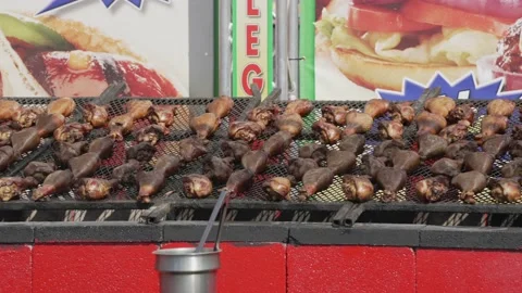 Panning turkey legs on large state fair grill Stock Footage 201961934