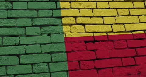 A panning video of a brick wall with the benin flag Stock Footage 337427202