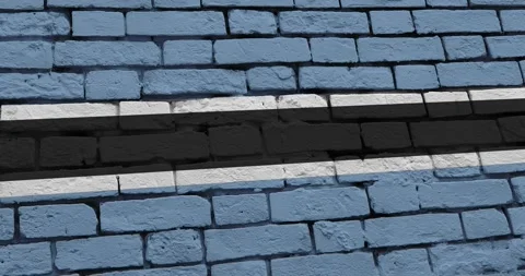 A panning video of a brick wall with the botswana flag Stock Footage 337427254
