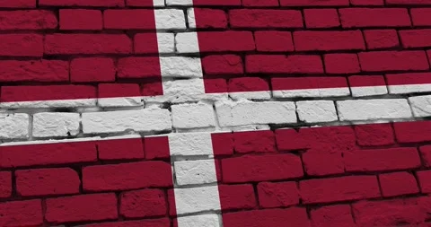 A panning video of a brick wall with the denmark flag Stock Footage 337428023