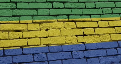 A panning video of a brick wall with the gabon flag Видео 337428683