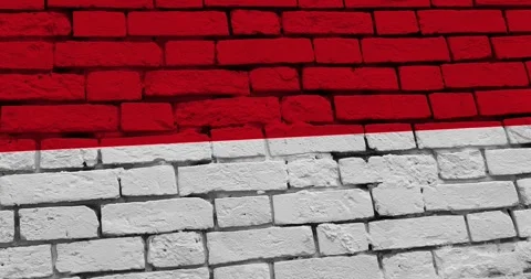 A panning video of a brick wall with the indonesia flag Video stock 337429036