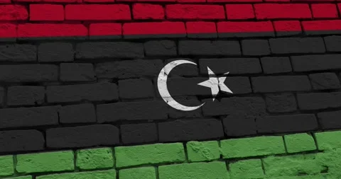 A panning video of a brick wall with the libya flag Video stock 337429660