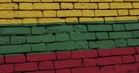 A panning video of a brick wall with the lithuania flag Video stock 337429645