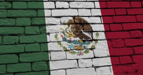 A panning video of a brick wall with the mexico flag Video stock 337429785