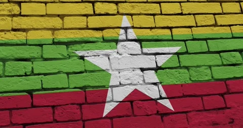 A panning video of a brick wall with the myanmar flag Stock Footage 337429770