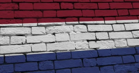 A panning video of a brick wall with the netherlands flag Video stock 337429905