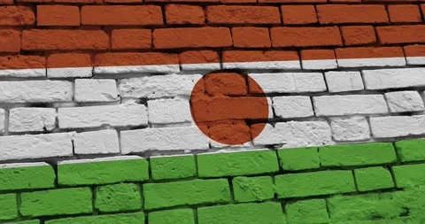 A panning video of a brick wall with the niger flag Stock Footage 337429943