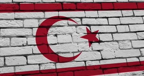 A panning video of a brick wall with the northern cyprus flag 스톡 동영상 337429885