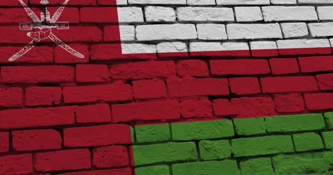 A panning video of a brick wall with the oman flag Видео 337431130