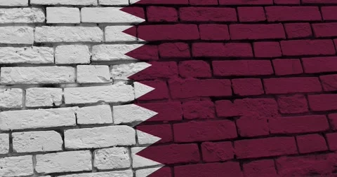 A panning video of a brick wall with the qatar flag Video stock 337431248