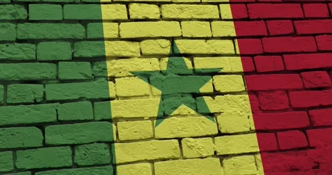 A panning video of a brick wall with the senegal flag Video stock 337431338