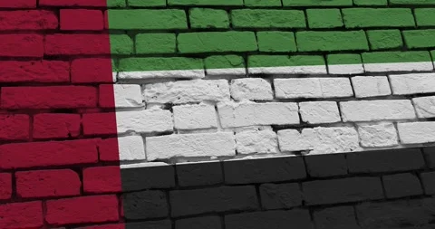 A panning video of a brick wall with the united arab emirates flag Video stock 337432629