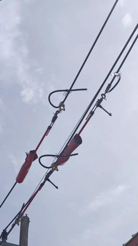 Panning video of cut high voltage space aerial cables secured with tension. Stock Footage 339049304