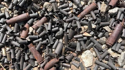 Panning video of spent bullet shells on the ground. Stock Footage 288371261