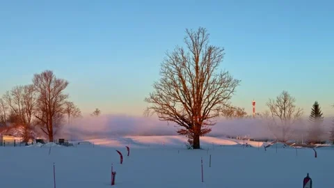 Panning view across snow covered winter landscape to dairy processing plant at Stock Footage 333309165