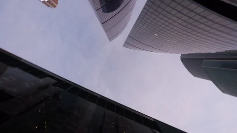 Panning view from below of the office tower buildings with vertical rotation Video stock 104825986