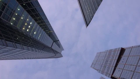 Panning view from below of the office tower buildings with rapid rotation Stock Footage 104828373