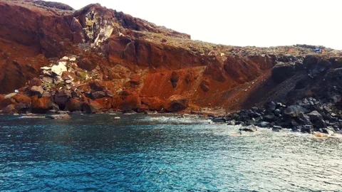 Panning view of blue dome churches and Caldera in Santorini Island Stock Footage 125979445