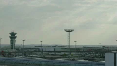Panning view from cloudy sky to Paris Orly airport building and road Stock Footage 153820997