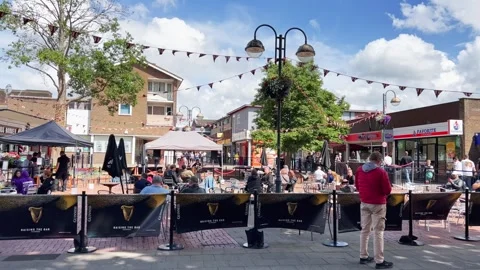 Panning view of crawley square with people drinking beer Stock Footage 280791871