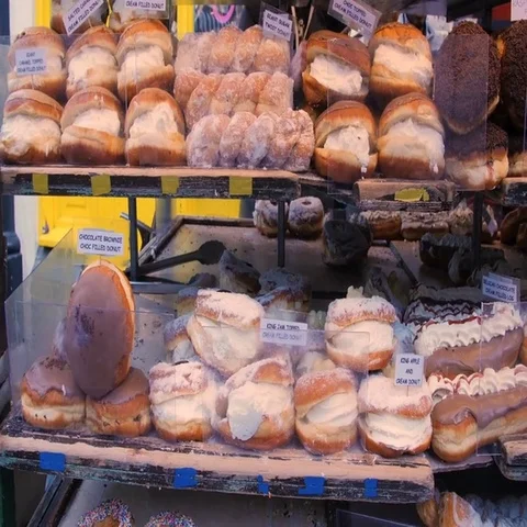 Panning view of different varieties of cakes and pastries at a food market Stock Footage 69486696