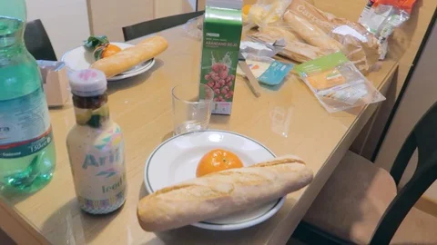 A panning view of a dinning table with breakfast bread and drinks. Stock Footage 122805199