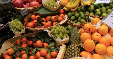 Panning view of a display of different variety of organic citrus fruits Stock Footage 69242318