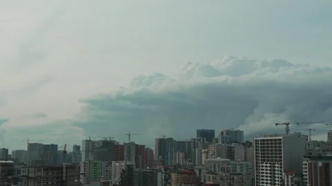 Panning view of dramatic storm clouds is approaching the city. Thunderstorm Stock Footage 335468325