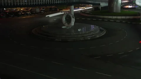 Panning view of dynamic night traffic light trails on roundabout. Timelapse of Stock Footage 335467734