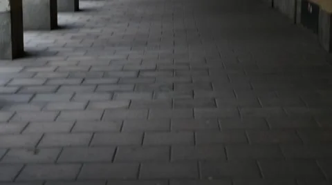 Panning view of hallway with many columns. Girl coming from behind pillars and Stock Footage 64920624