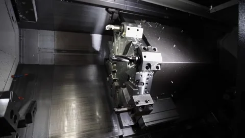 Panning view inside metal turning CNC controlled lathe tool booth 動画素材 306953974