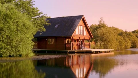Panning view of lodges on a lake in Anglesey North wales Video stock 163987166