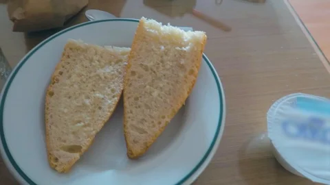 A panning view of a man on the dinning table having breakfast. Stock Footage 123883256