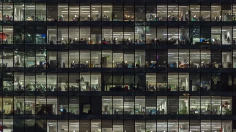 Panning up view of office windows with working people Stock Footage 142563454
