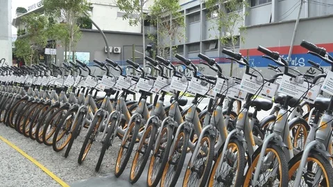 Panning view of a row of obike are parking in Pasar Seni, Kuala Lumpur. Видео 80858420