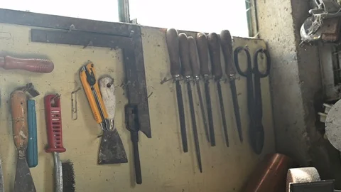 Panning view of several  work tools in a machine shop, mechanical workshop Stock Footage 105129599