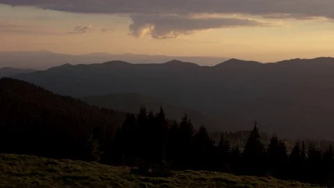 Panning View of Sunset Clouds Motion Over Hills, Mountains Silhouette. Stock Footage 76834268