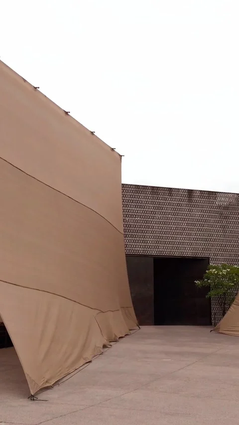 Panning View Toward Modern Courtyard Entrance Framed by Fabric Canopies and Stock Footage 337967569