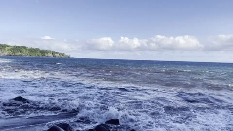 Panning view of waves crashing against rocks near Hana, Hawaii Stock Footage 186879416